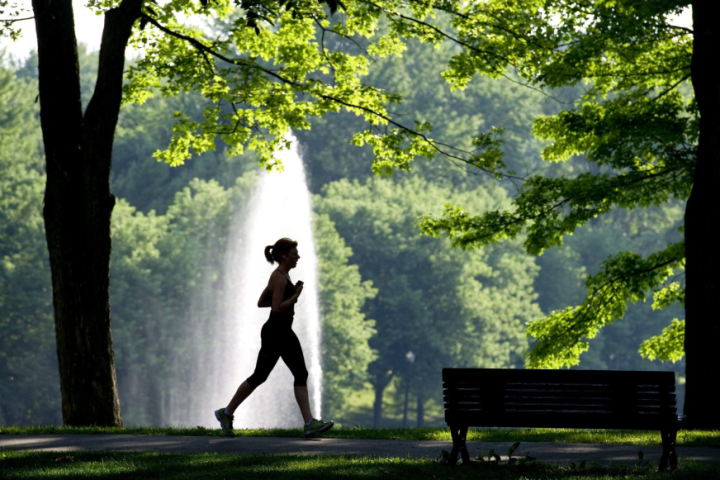 A woman jogs during the cool morning air in a downtown Montreal park Thursday, July 28, 2011 with daytime temperatures expected to hit the 30's C. THE CANADIAN PRESS/Paul Chiasson